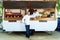 Handsome young chef looking at camera in a food truck.