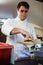 Handsome young chef preparing meatballs in a food truck.