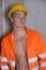 Handsome young construction worker with orange suit and hardhat