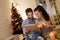 Handsome young couple shopping with tablet at New Years eve at home