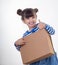Handsome young girl delivering package over white background. Internet purchases