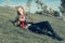 A handsome young guy in a khaki and berets military coat, lay down on the grass on a halt