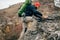 Handsome young hiker man hikking in the mountains. Traveler bearded man trekking during his journey.