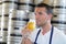 handsome young male brewer in apron tasting fresh beer