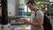 Handsome young man in airport terminal. Standing near charging stand pluging in smartphone