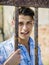 Handsome young man behind metal cage bars