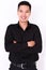 Handsome young man in black shirt keeping arms crossed and smiling  on white background , Asia Portrait
