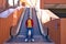 A handsome young man with blue eyes and beard stands next to an escalator in a shopping mall. The man makes different poses and