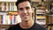 Handsome young man in bookstore smiling