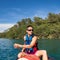 Handsome young man on a canoe on a lake, paddling