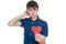 Handsome young man in denim blue shirt standing on a white background with a red paper heart in hands.