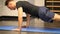 Handsome young man doing push-ups exercise on mat