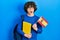 Handsome young man exchange student holding spanish flag angry and mad screaming frustrated and furious, shouting with anger