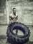 Handsome young man exercising flipping huge tire