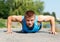 Handsome young man in good shape doing push-up while outdoor tra