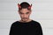 Handsome young man with Halloween horns on his head