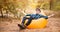 Handsome young man in hat and sunglasses lying on inflatable sofa. Happy man enjoy free time on open air while resting on grass in