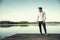 Handsome young man on a lake in a sunny, peaceful