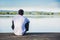 Handsome young man on a lake in a sunny, peaceful