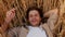 Handsome Young Man Lying In Wheat Field With Hand Behind Head