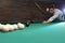 Handsome young man playing Russian billiard. Space for text