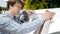 Handsome young man polishing car headlamps with cloth