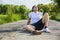 Handsome young man resting sitting on road after