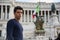 Handsome young man in Rome in front of Vittoriano monument