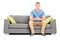 Handsome young man sitting on a modern sofa