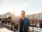 Handsome young man standing on the rooftop