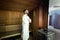 Handsome young man standing in sauna smiling