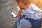 Handsome young man using smart phone while standing outdoors at sunny evening