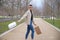 Handsome young man wearing make up and earphones  turning around and carrying shopping bags