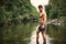 Handsome young muscle man standing in water pond, naked