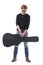 Handsome young red hair rocker man holding acoustic guitar black leather case looking down.