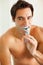 Handsome young shirtless man brushing his teeth. Personal hygiene - Portrait of a happy young man brushing his teeth.