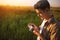 Handsome young traveler man with vintage camera,on a green meadow background. Travel mood. Photography.