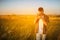 Handsome young traveler man with vintage camera, take a picture of a meadow. Travel mood. Photography.