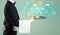 Handsome young waiter in tuxedo holding money icons on tray