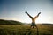 Handstand woman in a sunset mountain top