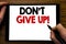Handwriting Announcement text showing Don t Give Up. Business concept for Motivation Determination, Written on tablet laptop, wood