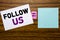 Handwriting Announcement text showing Follow Us. Business concept for Social Media Marketing written on sticky note paper on woode