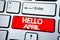 Handwriting Announcement text showing Hello April. Business concept for Spring Welcome written on red key on the keybord backgroun