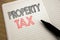 Handwriting Announcement text showing Property Tax. Business concept for Estate Income Taxation written on notebook with copy spac