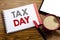 Handwriting Announcement text showing Tax Day. Business concept for Income taxation Refund Written on notepad note paper on wooden