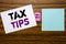 Handwriting Announcement text showing Tax Tips. Business concept for Tip Forn Taxes written on sticky note paper on wooden backgro