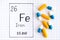 Handwriting chemical element Iron Fe with pills