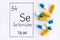 Handwriting chemical element Selenium Se with pills