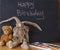 Handwriting message on chalk board with felt doll