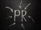 Handwriting of PR abbreviation Public Relation on chalkboard